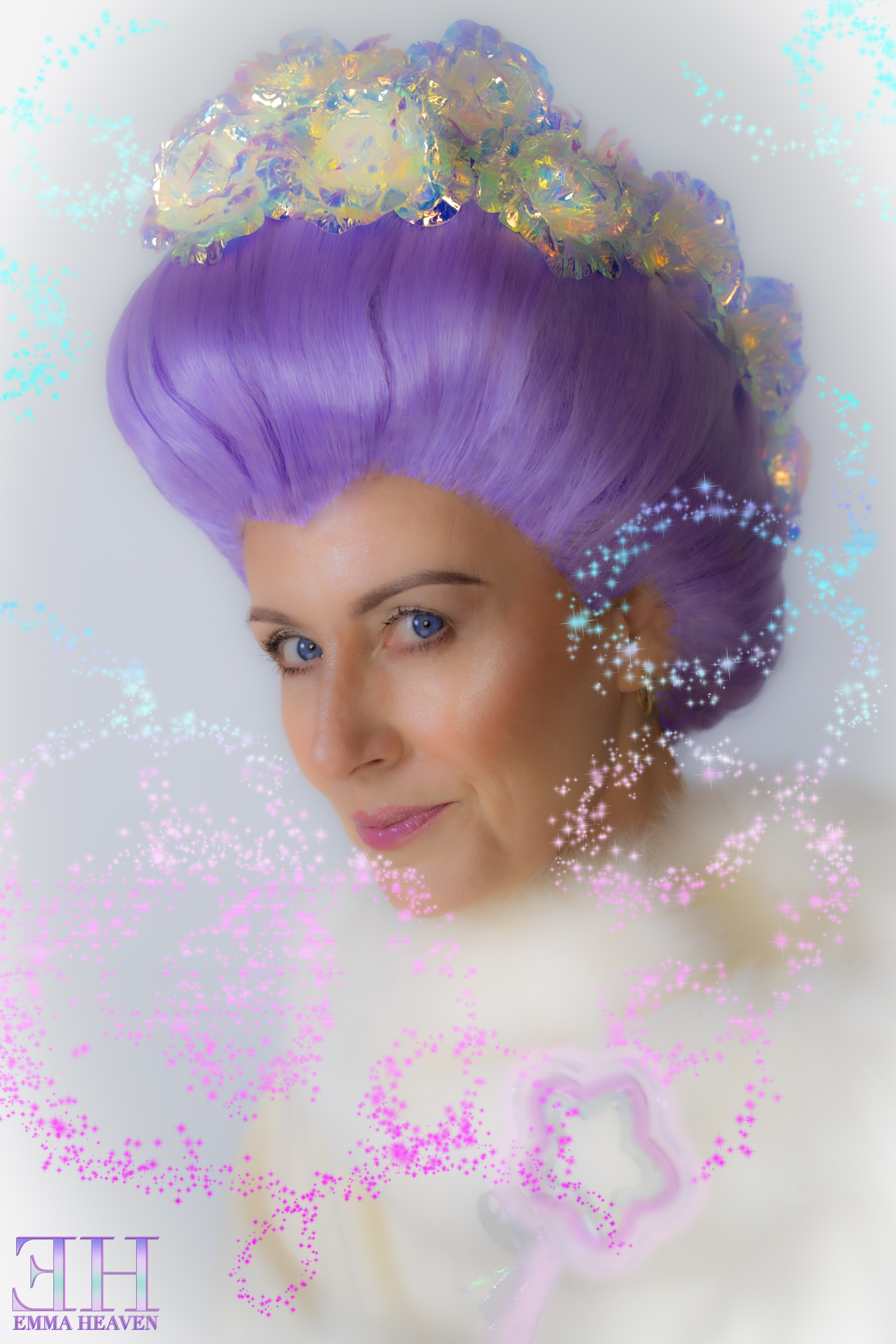 Close-up portrait of a woman with lavender hair styled in an elaborate updo, adorned with a colorful floral headpiece, sparkling with glittery effects and set against a soft background.